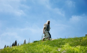 Jesus figure walking on a hill